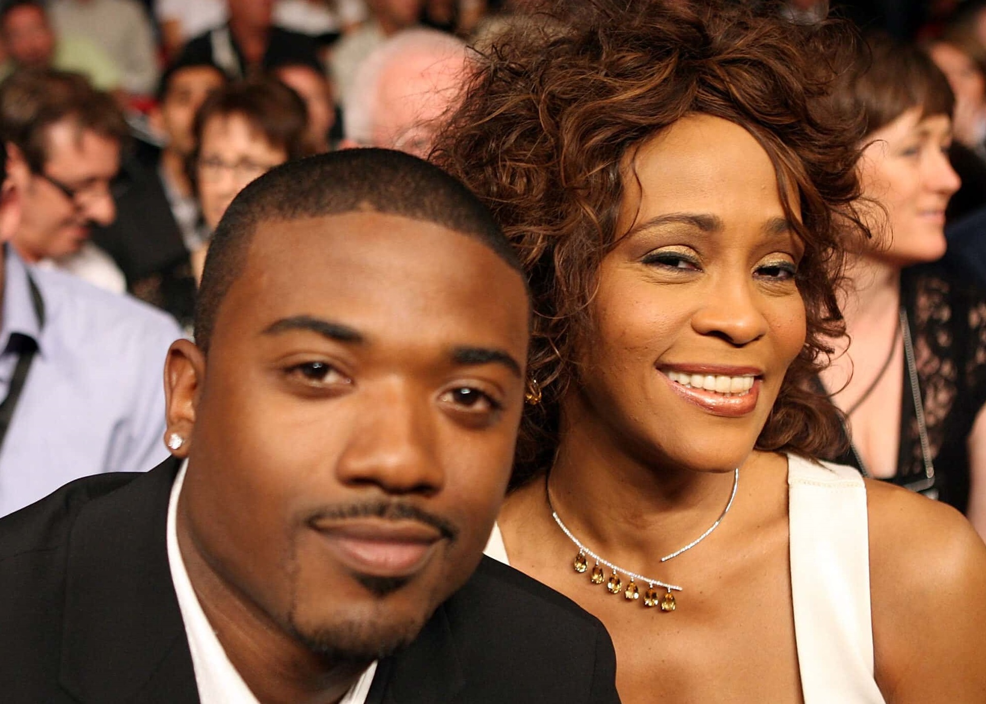 Whitney Houston and Ray-J are looking and smiling at camera - 2019