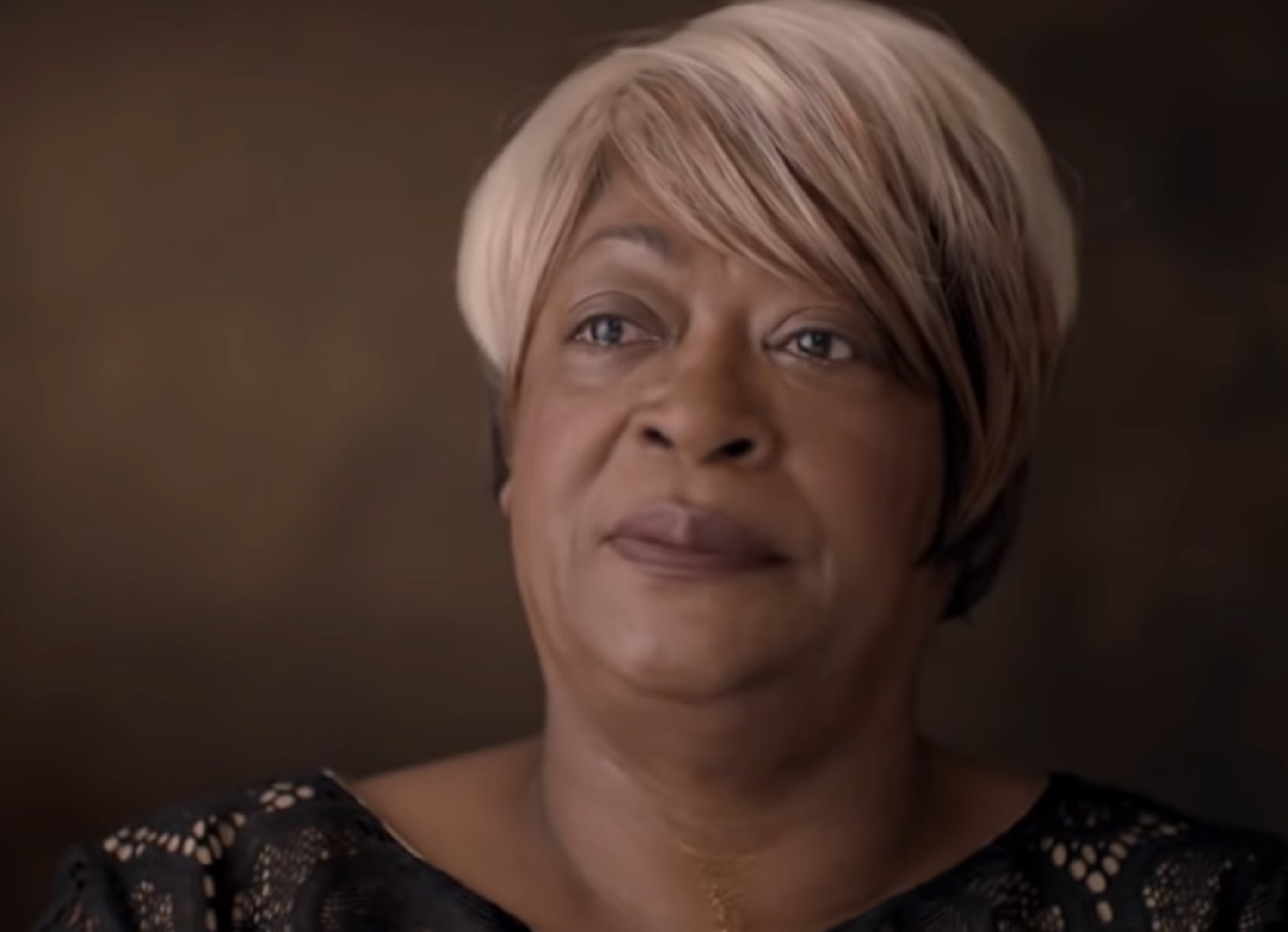 Screenshot of Mary Jones is talking at camera - from Whitney (2018)