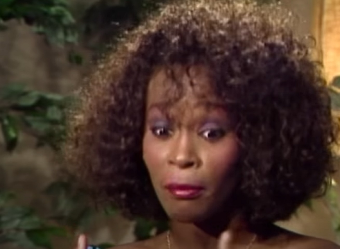 Screenshot of Whitney Houston is looking down with upset face - from Whitney (2018)