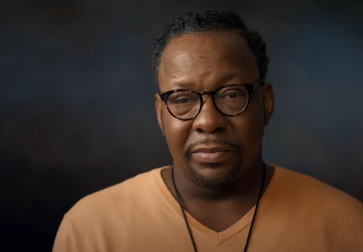 Screenshot of Bobby Brown is looking at camera with sad face - from Whitney (2018)