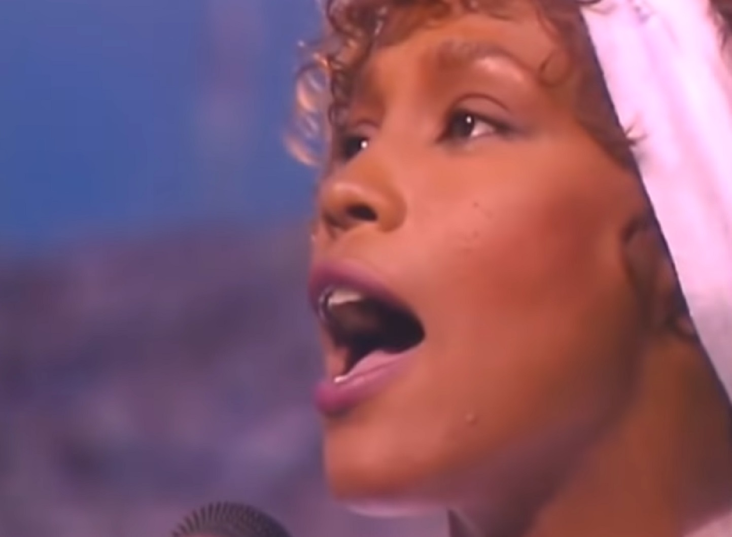 Whitney Houston is looking at side and singing - from Whitney (2018)