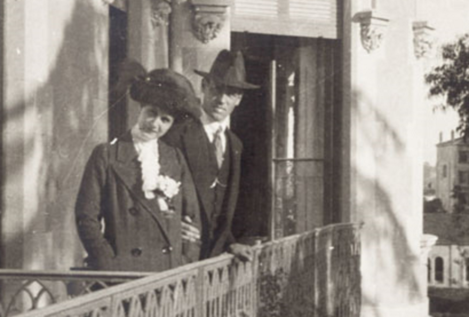 Grand Duke Michael And Natalia Brasova wearing hats, standing and looking at camera - circa 1913