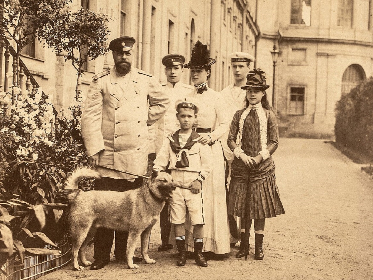 Emperor Alexander III, Tsarevitch Nicholas, Grand Duke Michael, Empress Marie Feodorovna, Grand Duke George and Grand Duchess Xenia. Taken outside the Imperial palace at Gatchina. - 1886