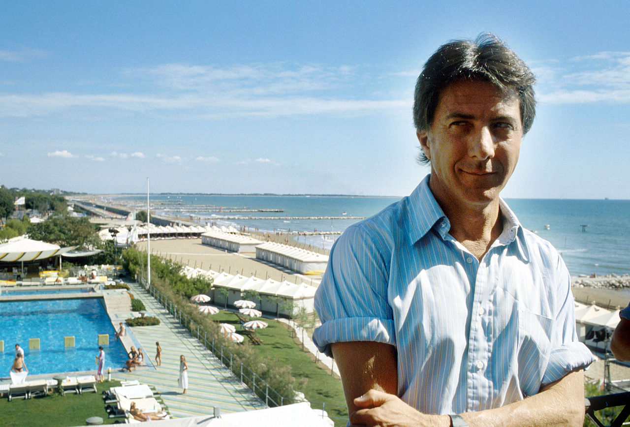 Dustin Hoffman in blue shirt looking at the camera