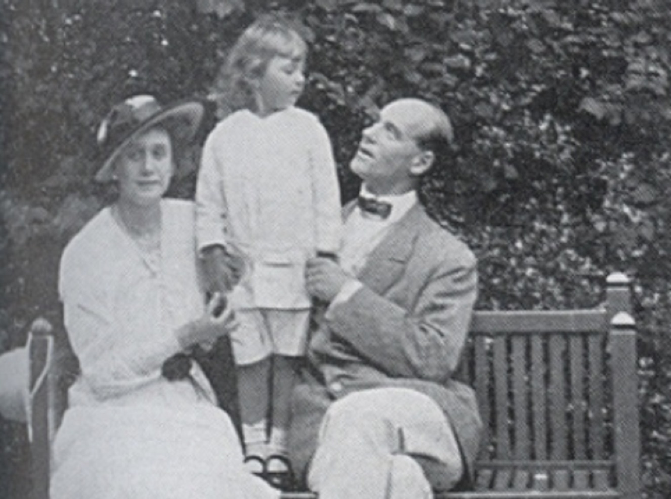 B&W photo of Grand Duke Michael Alexandrovich, his wife and son seating on the bench outside - circa 1910