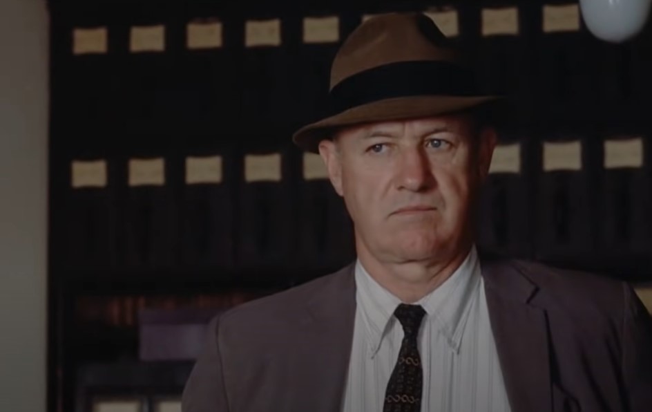 Gene Hackman in Mississippi Burning, wearing a suit and a hat