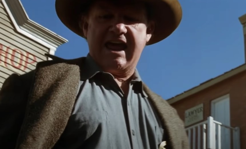 Gene Hackman in Unforgiven wearing a jacket and a hat angry yelling