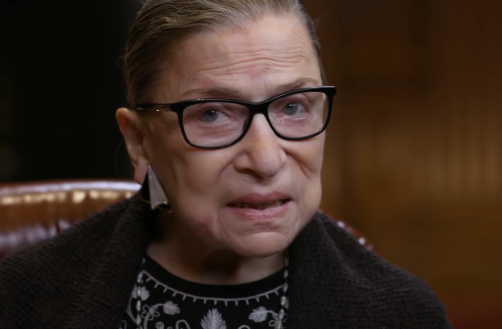 Ruth Bader Ginsburg in black sweater speaking