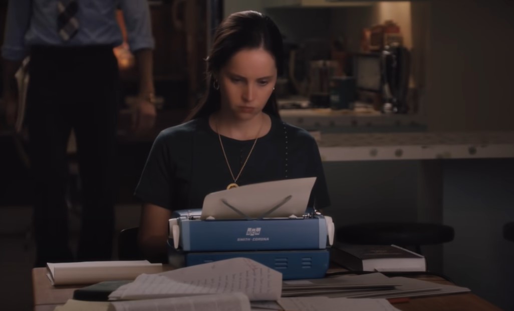 Felicity Jones as Ruth Bader Ginsburg working on typing machine at home in t-shirt
