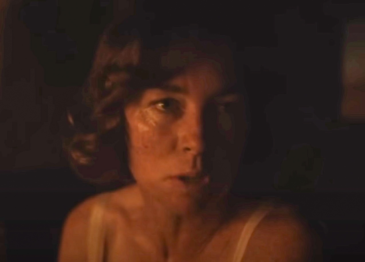 Screenshot: Gladys Pearl Baker (Julianne Nicholson) is standing in dark room - from Blonde (2022)