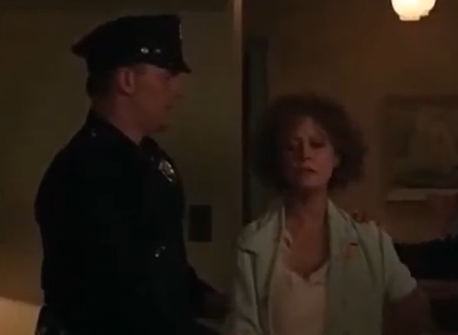 Screenshot: Gladys Pearl Baker (Susan Sarandon) is standing next to police officer - from The Secret Life of Marilyn Monroe (2015)
