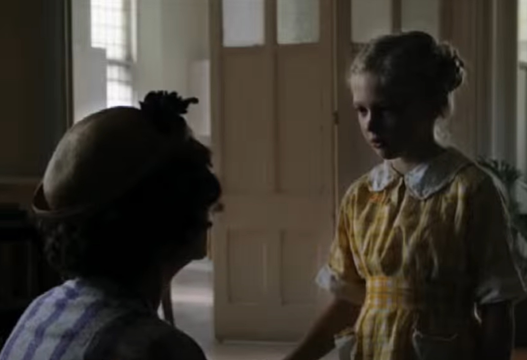 Screenshot: Gladys Pearl Baker (Susan Sarandon) is talking with a girl in hallway - from The Secret Life of Marilyn Monroe (2015)