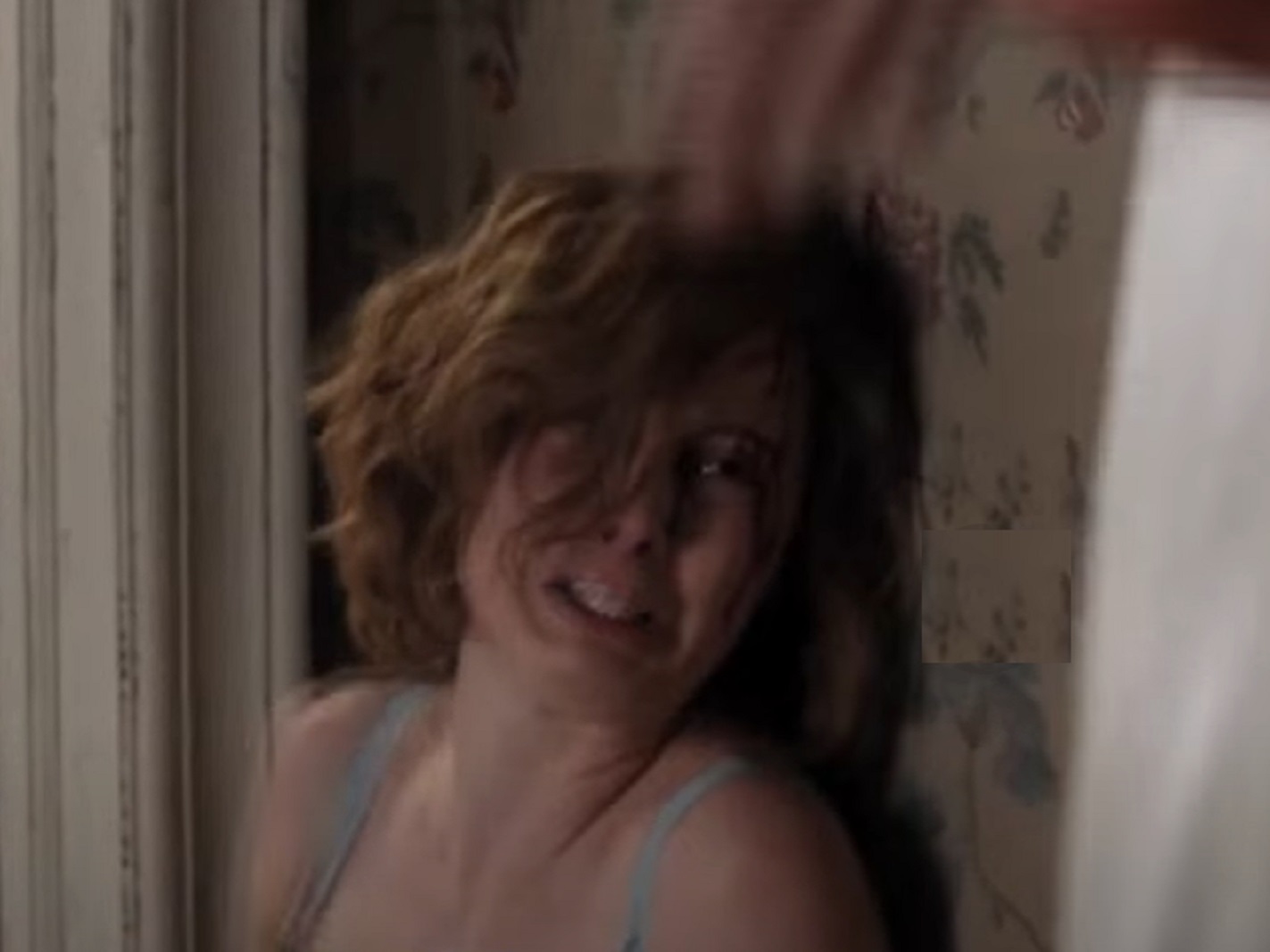 Screenshot: Gladys Pearl Baker (Susan Sarandon) is seating on the ground and crying - from The Secret Life of Marilyn Monroe (2015)