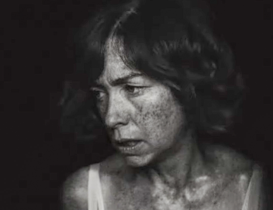 Screenshot: Gladys Pearl Baker (Julianne Nicholson) is looking at side on black background - from Blonde (2022)