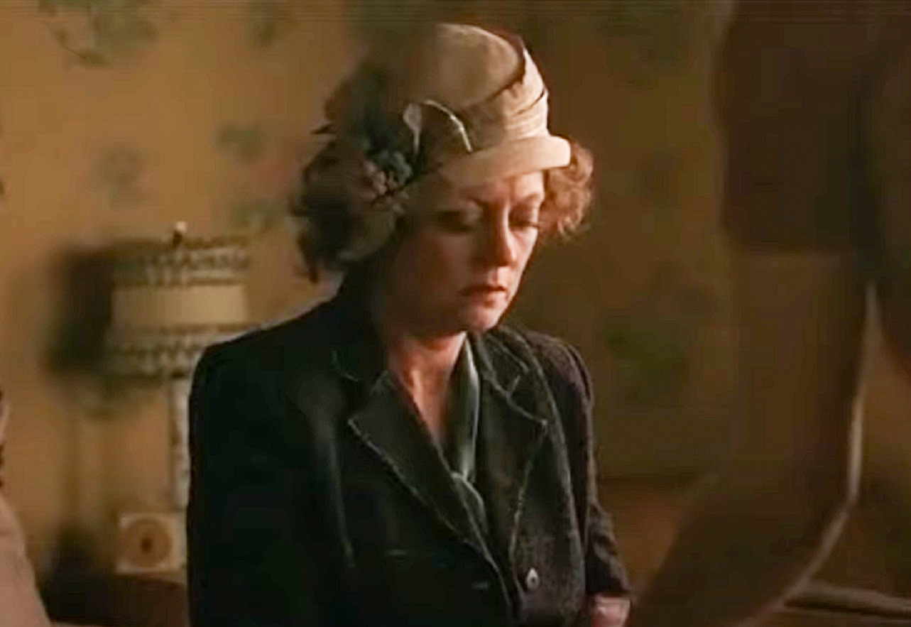 Screenshot: Gladys Pearl Baker (Susan Sarandon) is seating on the bed with sad face - from The Secret Life of Marilyn Monroe (2015)