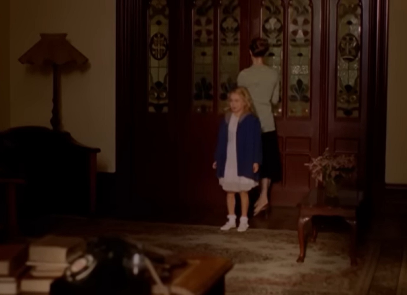 Screenshot: Young girl (Marilyn Monroe) is standing in hallway - from Blonde (2001)