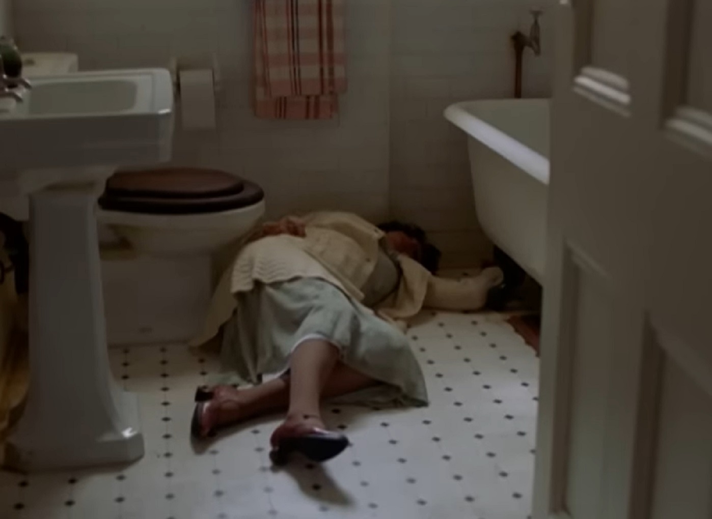 Screenshot: senior woman is laying on the bathroom floor - from Blonde (2001)