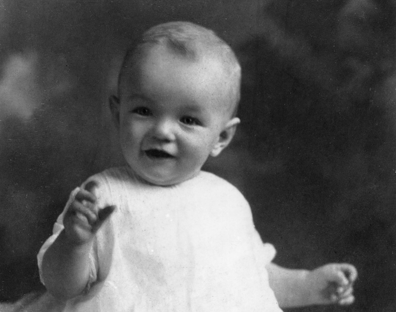 Marilyn Monroe As An Infant wearing white shirt and smiling - 1927