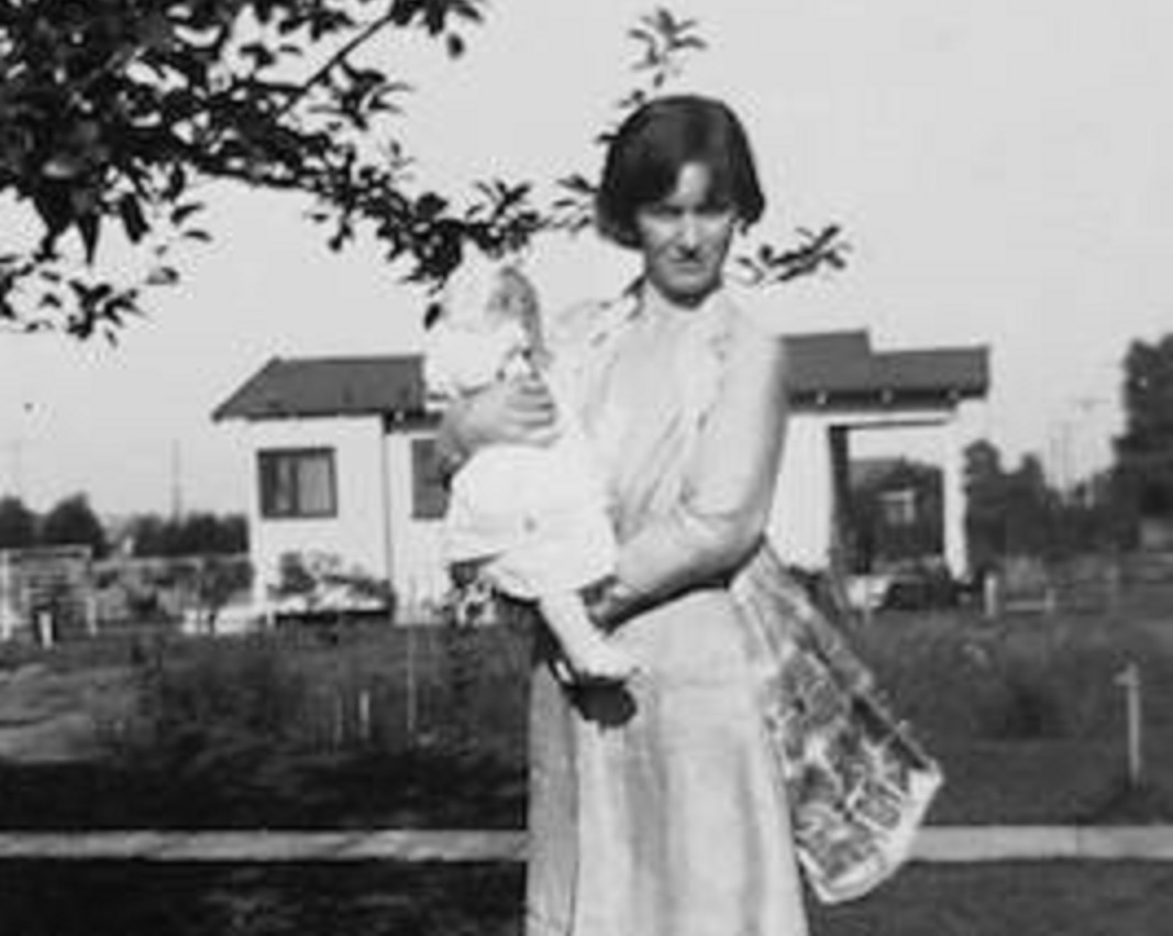 Gladys Pearl Monroe Baker Holding Norma Jeane, Future Marilyn Monroe outside and looking at camera.