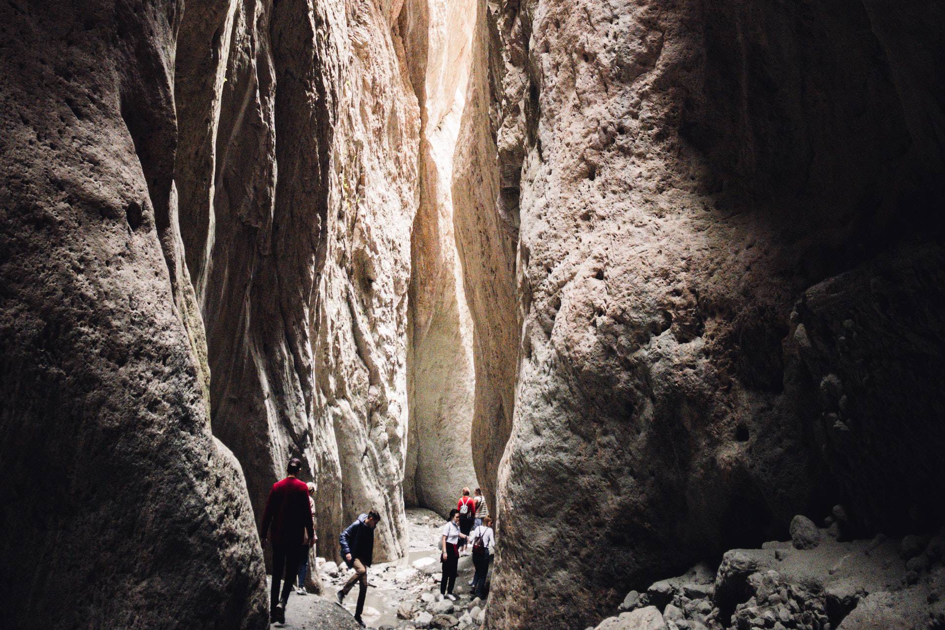 People hiking at a cave