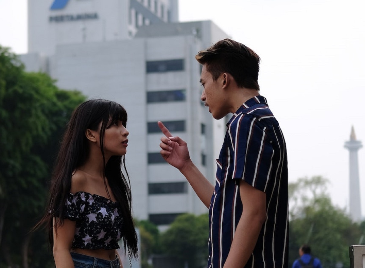 Young couple are arguing outside.