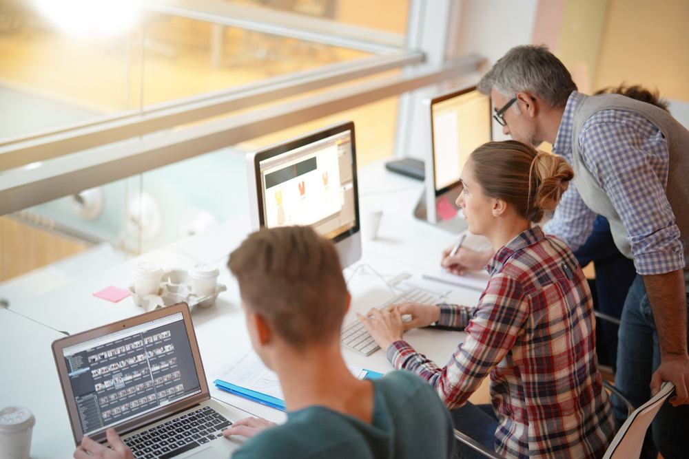 Teacher with students in graphic design class