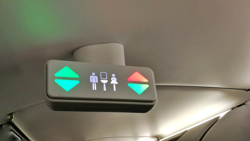 A lavatory sign on plane