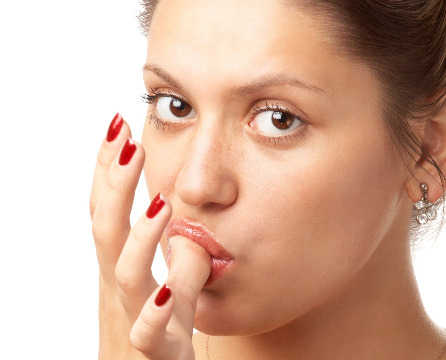 Young girl licking her thumb and looking at camera.