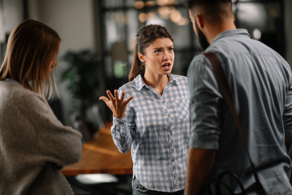 Three people having an argument in office wearing casual clothes
