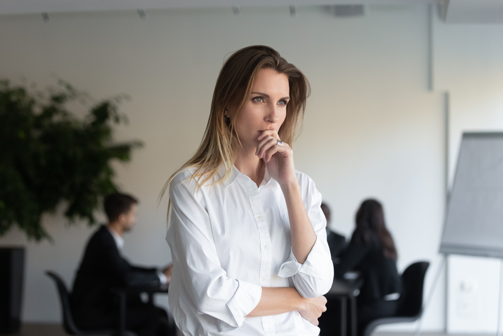 Confused woman in office wearing white shirt