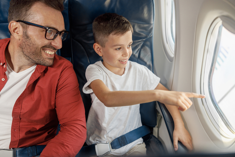 Father and son traveling by plane