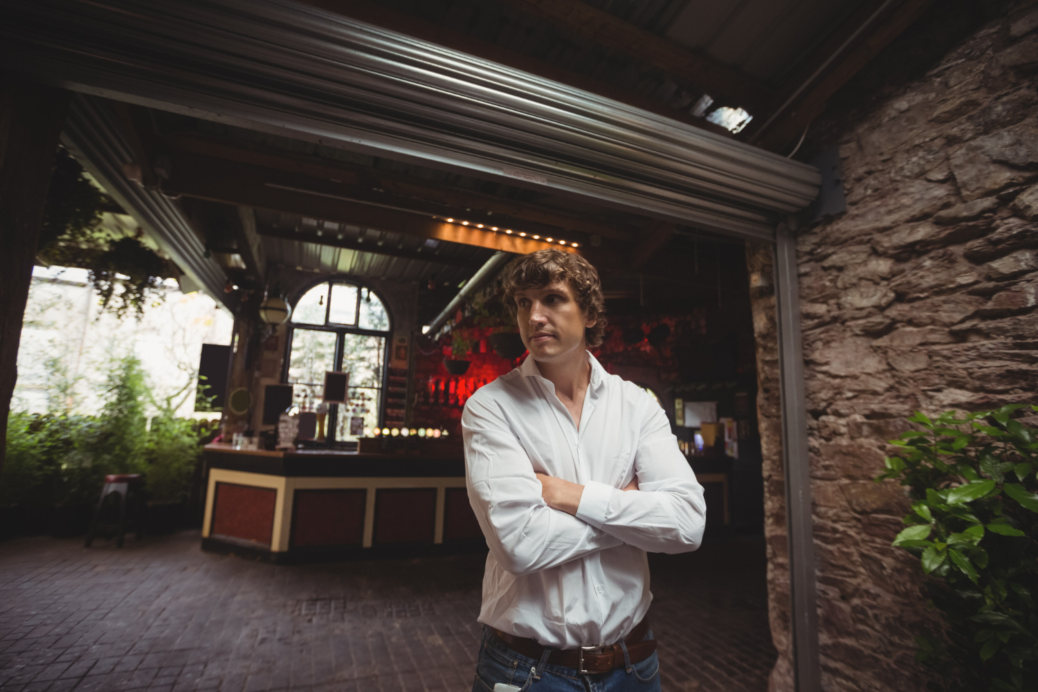 Man is standing with arms crossed and looking upset.