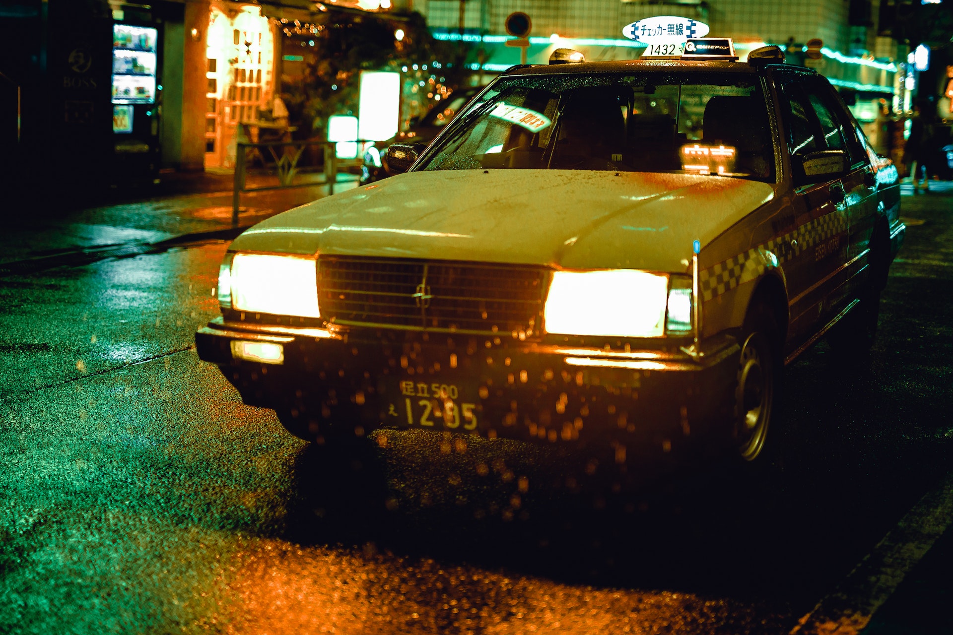Yellow taxi on the street at night