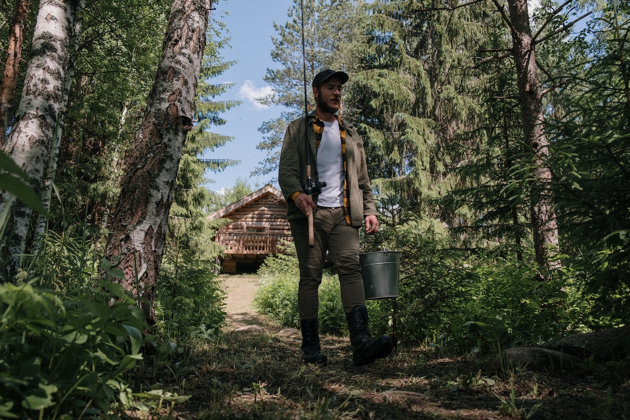 Man holding a fishing rod and walking.