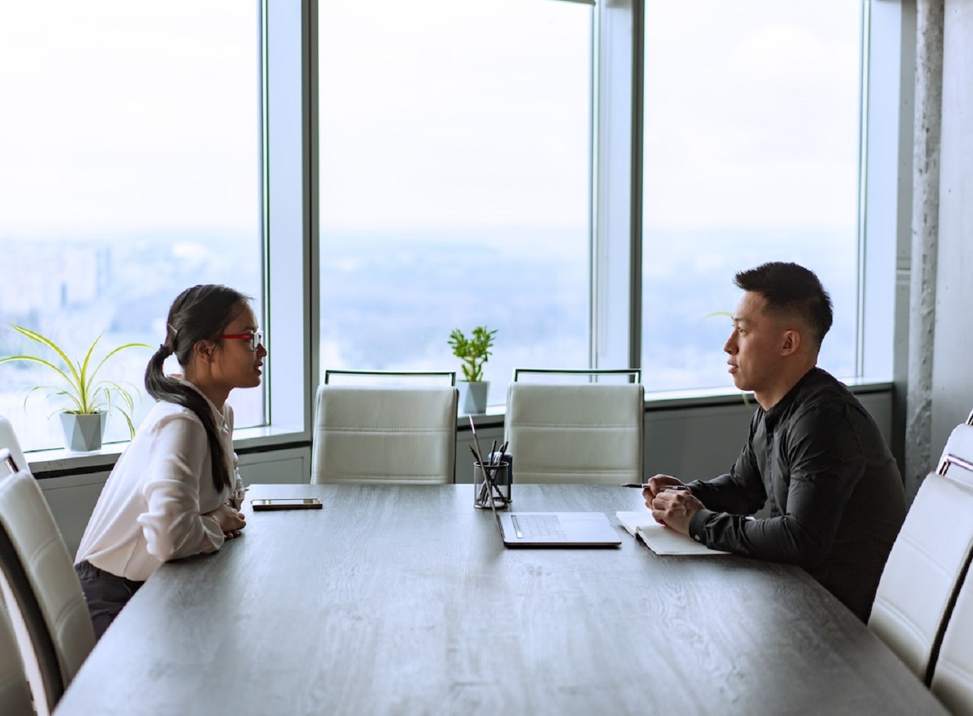 Two young people are taking at office about work.