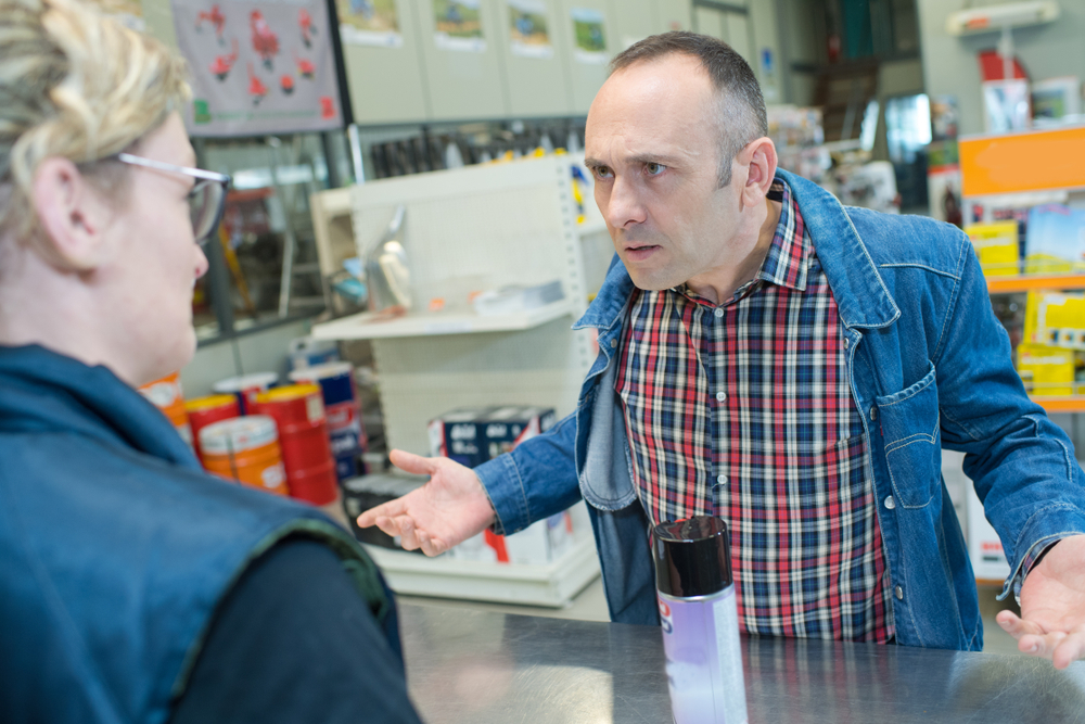 Aggressive customer at shop counter yelling
