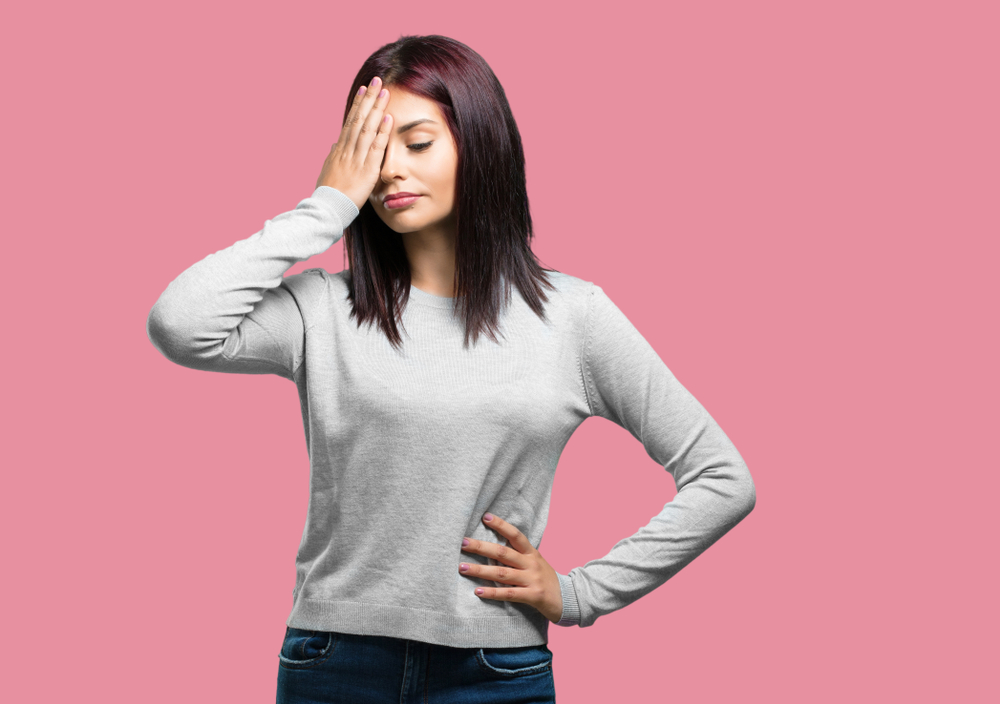 Young pretty woman realized something with expression of shock at having made a mistake in white sweater