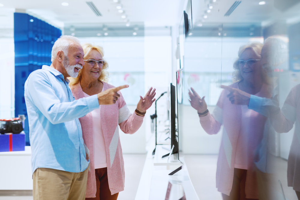 Happy cute Caucasian senior couple at store