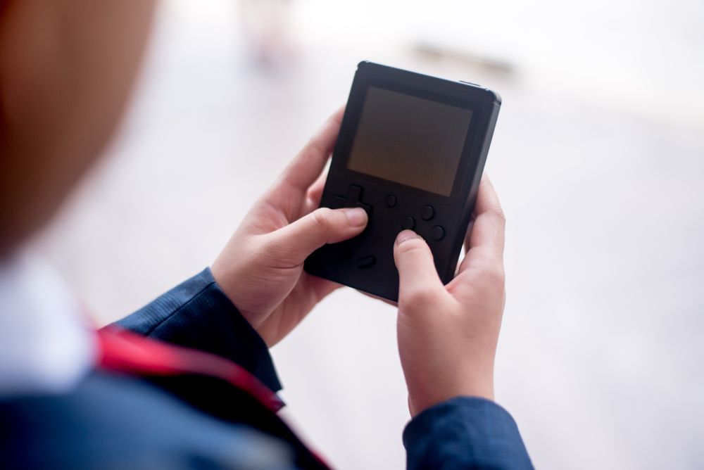 boy playing video game in school