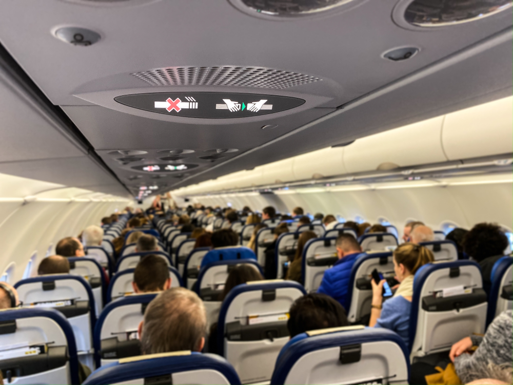Cabin of a modern airplane filled with passengers