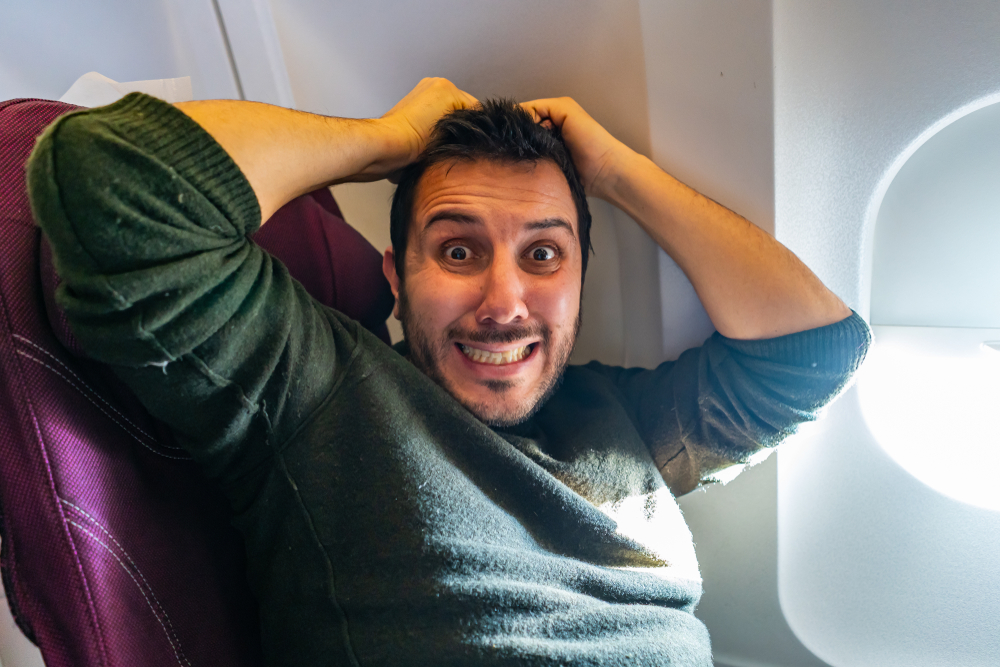 Man passenger afraid of flying on an airplane
