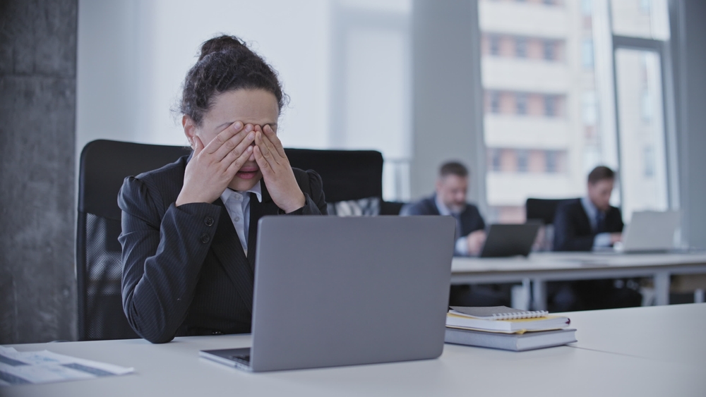 Depressed business woman crying in office