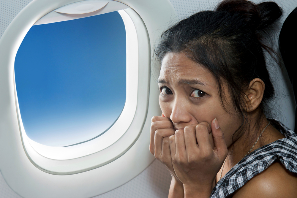 frightened woman on plane