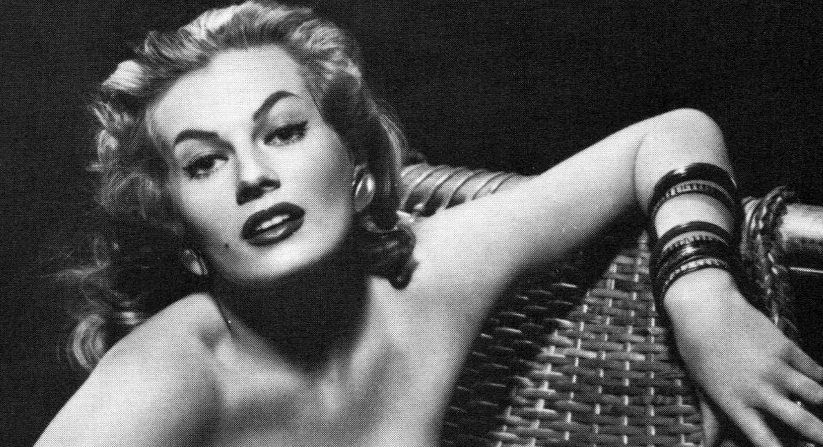 Anita Ekberg wearing earrings sitting on an armchair