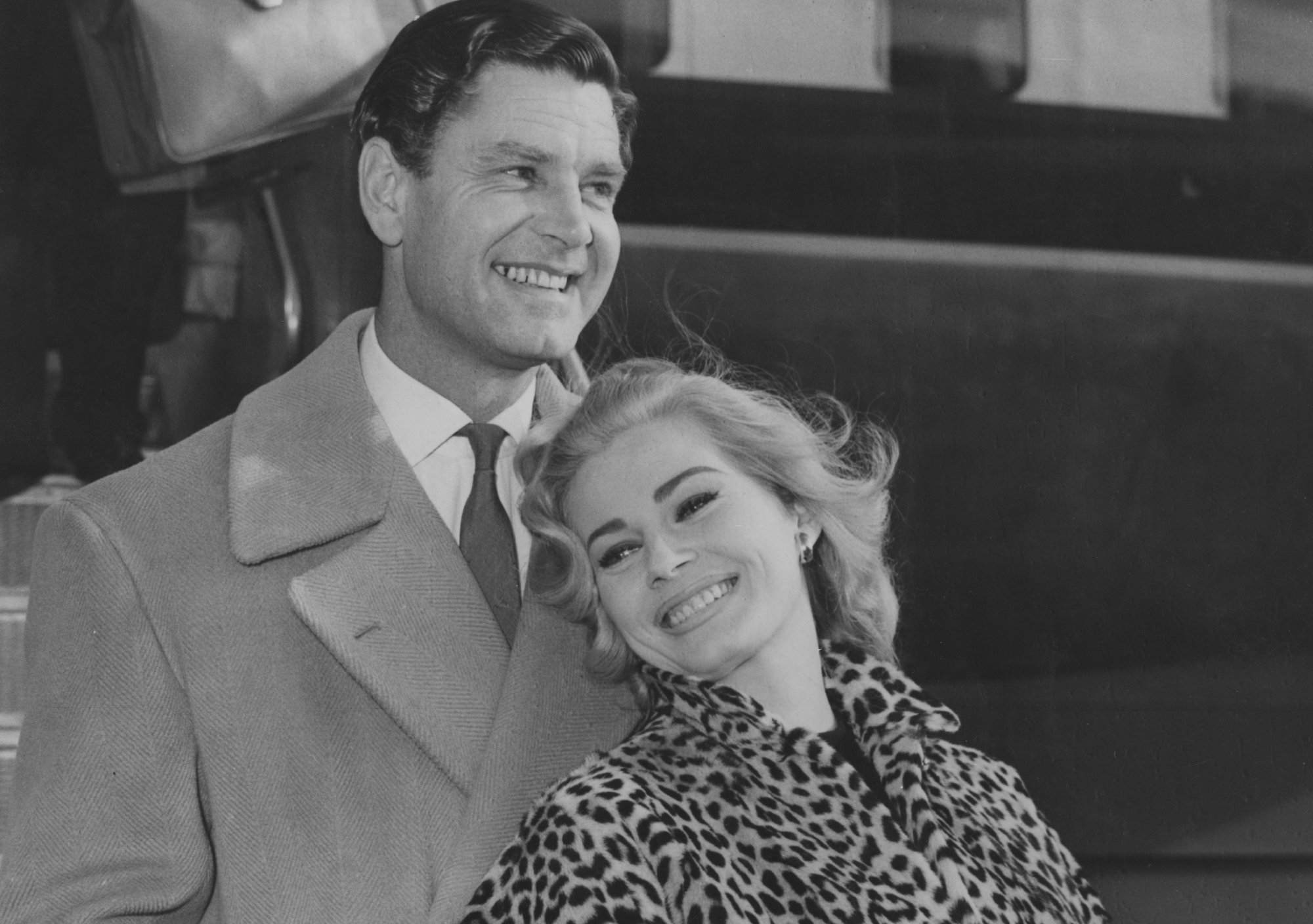 Anita Ekberg and husband at airport wearing coats
