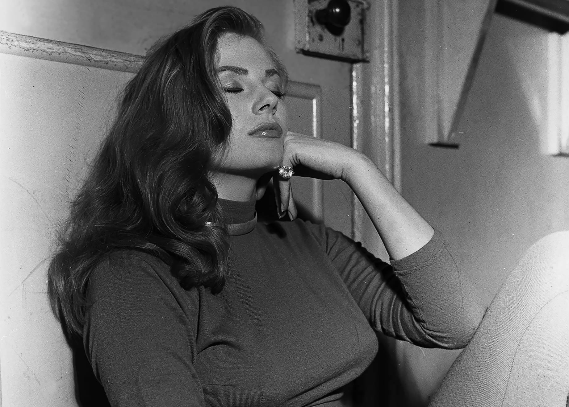 Actress Anita Ekberg sitting on floor December 1955