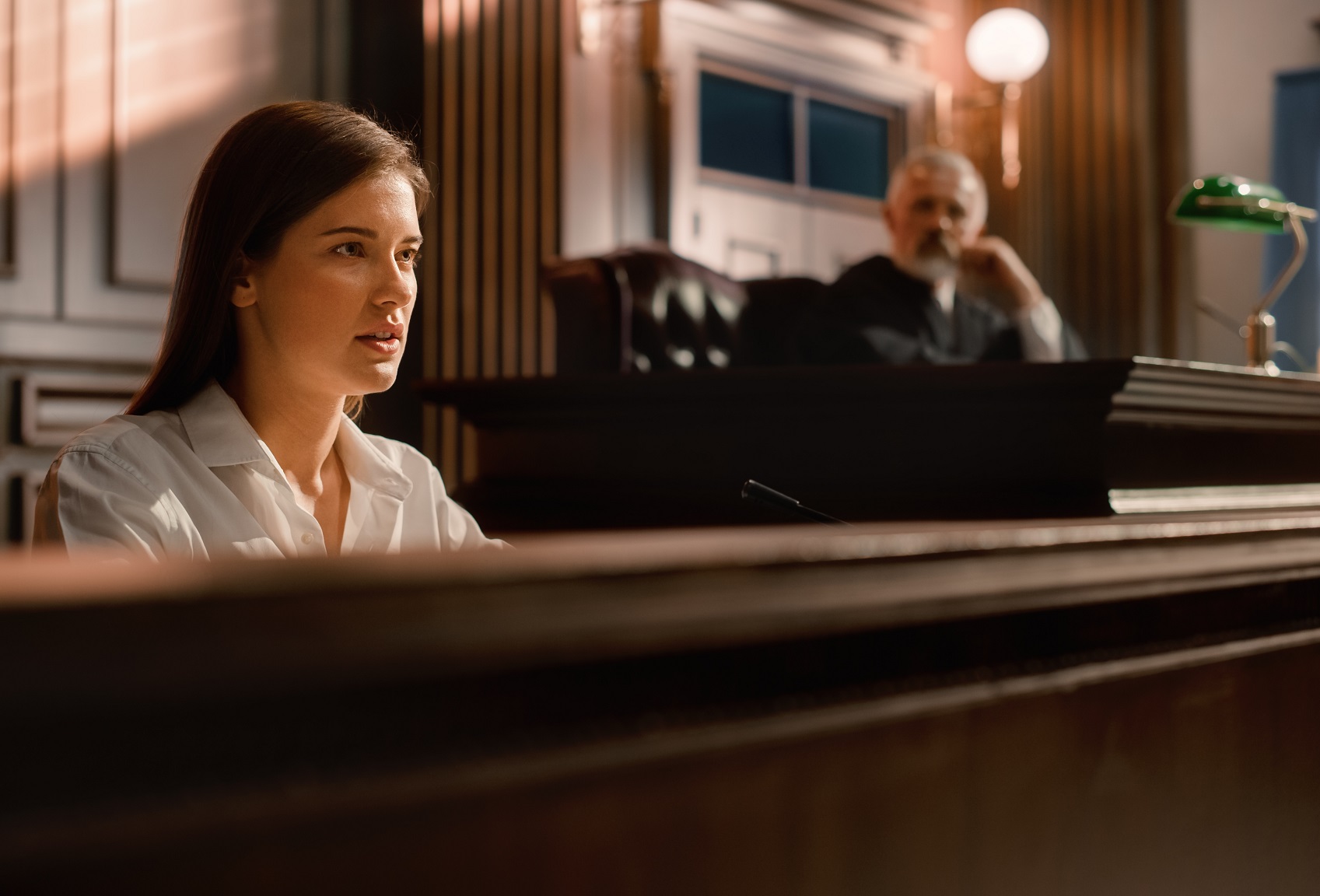 Portrait of beautiful female giving heartfelt testimony at courtroom.