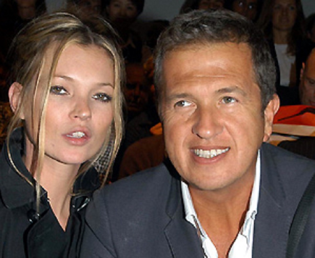 Kate Moss is standing next to Mario Testino smiling at side - 2005