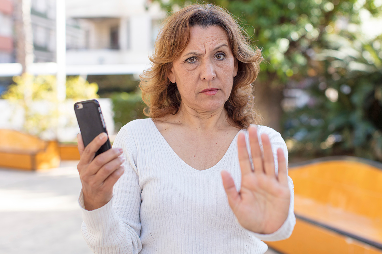 Side view of handsome young chef using peel to put pizza in oven for baking