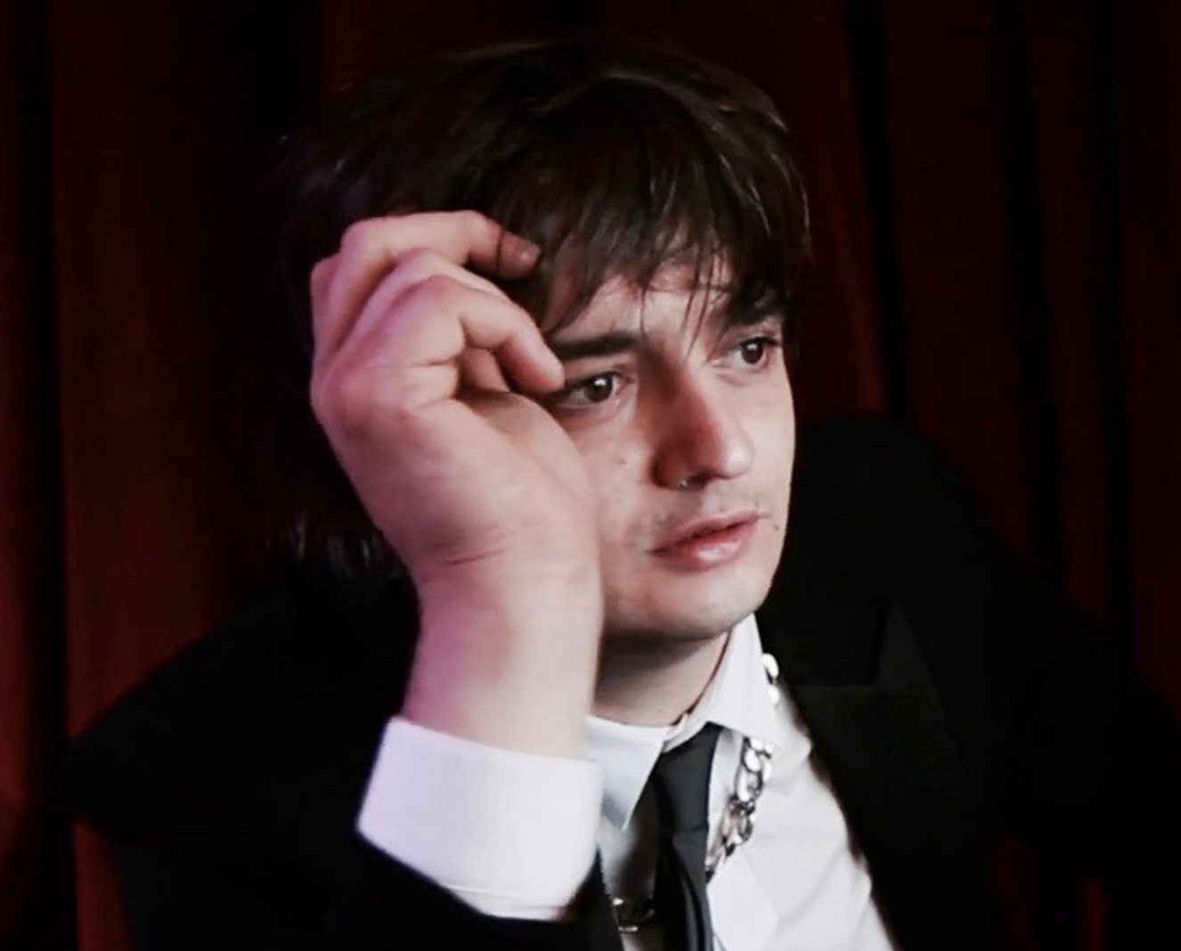 Pete Doherty is looking at side with surprised face - 2012